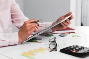 How can a firm improve its profit margins through outsourcing?